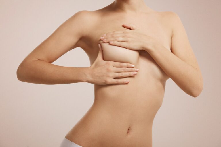 Breast cancer self check, healthy lifestyle concept. Young pretty woman examining her breast for lum